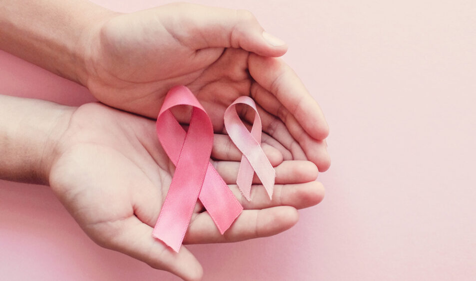 deux mains qui tiennent de ruban rose pour la lutte contre le cancer du sein