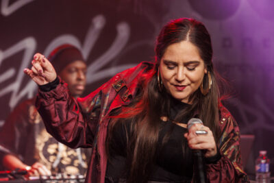 la chanteuse Billie Brelok tenant son micro pour le concert de Villeneuve-la-Garenne - Agrandir l'image 1 sur 6, fenêtre modale